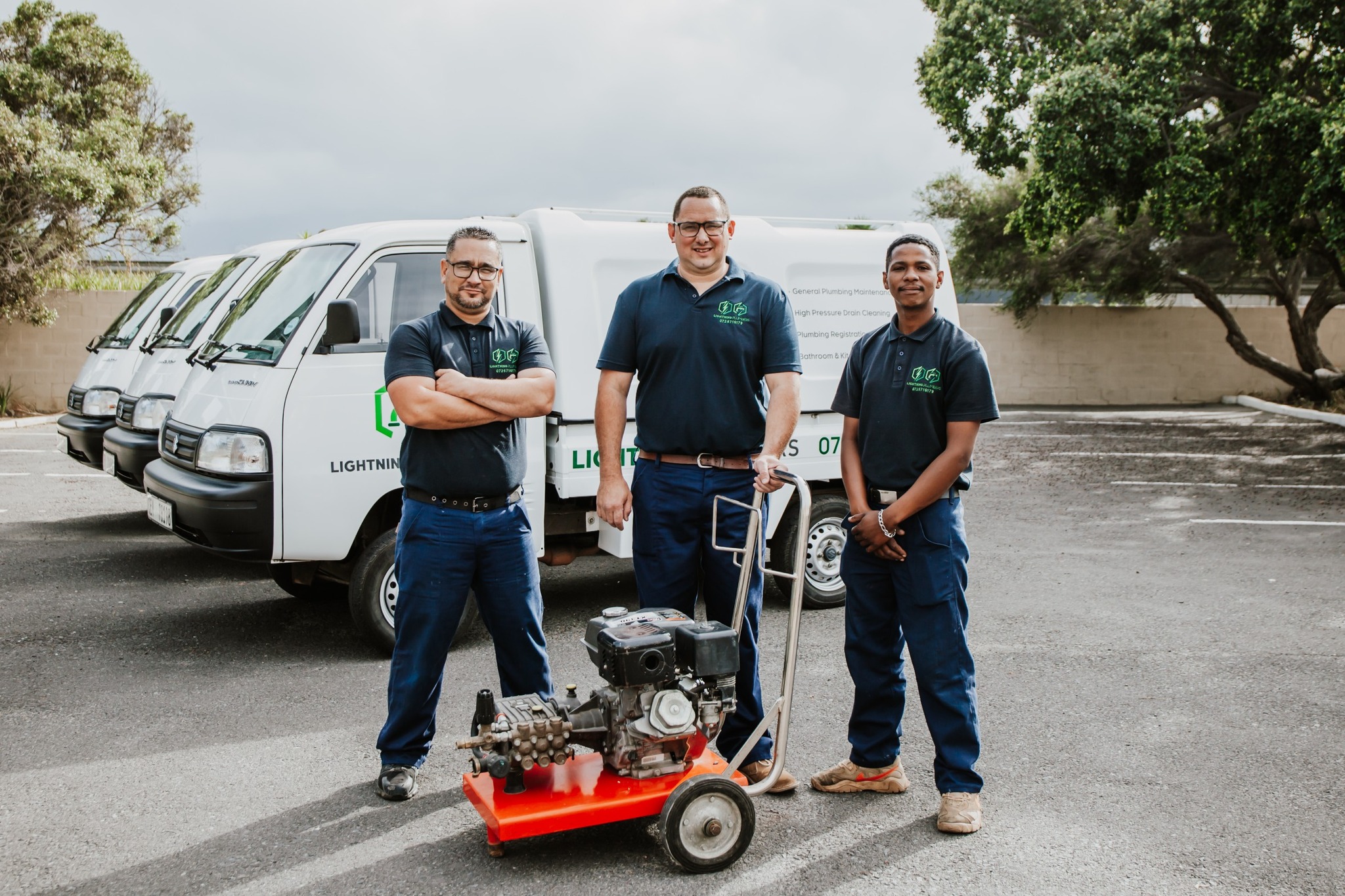 Team with high pressure drain cleaning equipment